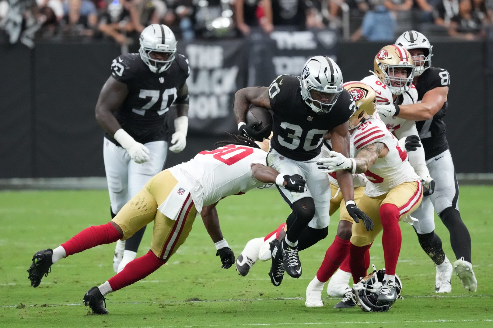 Las Vegas Raiders running back Mike Washington Jr. runs against San Francisco 49ers defenders