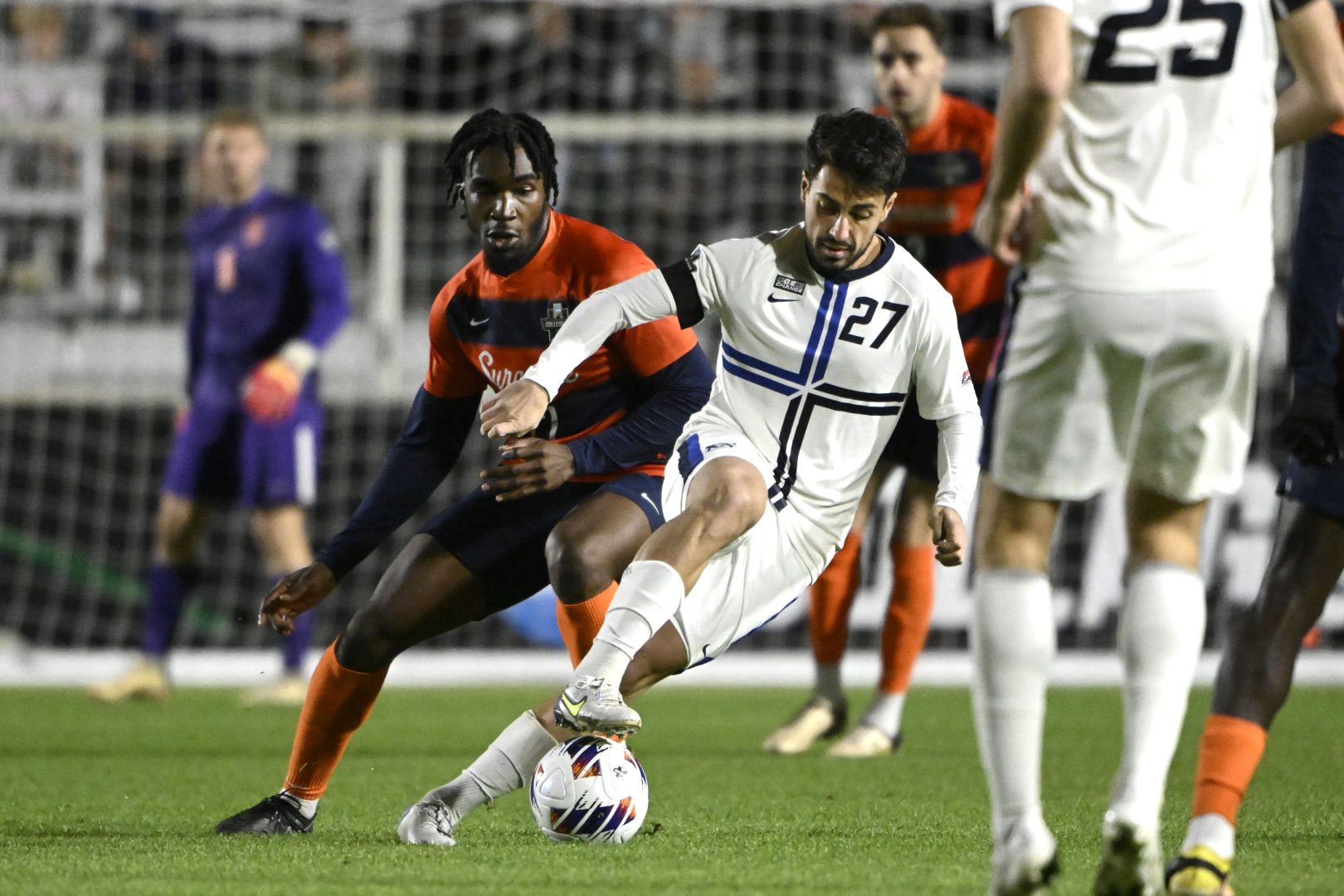 Creighton midfielder Giorgio Probo controls the ball as Syracuse defender Olu Oyegunle defends