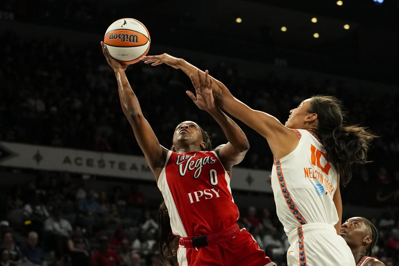 Las Vegas Aces guard Jackie Young shoots a layup against Connecticut Sun center Olivia Nelson-Ododa