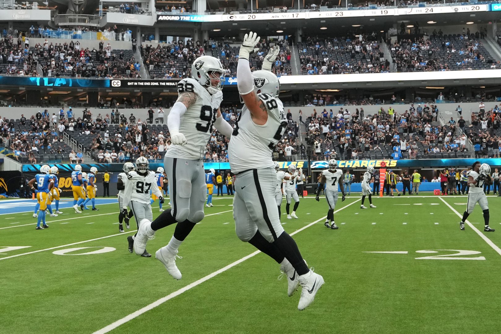 Las Vegas Raiders defensive end Maxx Crosby and guard Jackson Powers-Johnson celebrate a safety against the Los Angeles Chargers