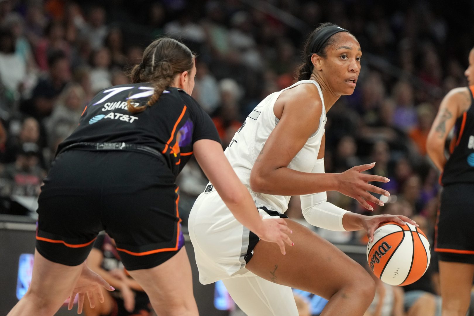 Las Vegas Aces center A'ja Wilson shields the ball from Phoenix Mercury forward Marta Suarez