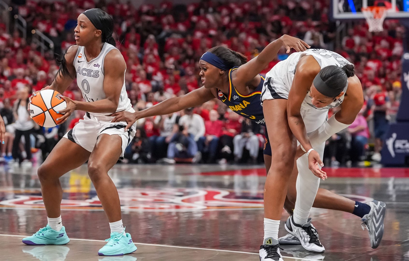 Indiana Fever guard Raven Johnson reaches for the ball against Las Vegas Aces guard Jackie Young during Game 2 of the WNBA Playoffs