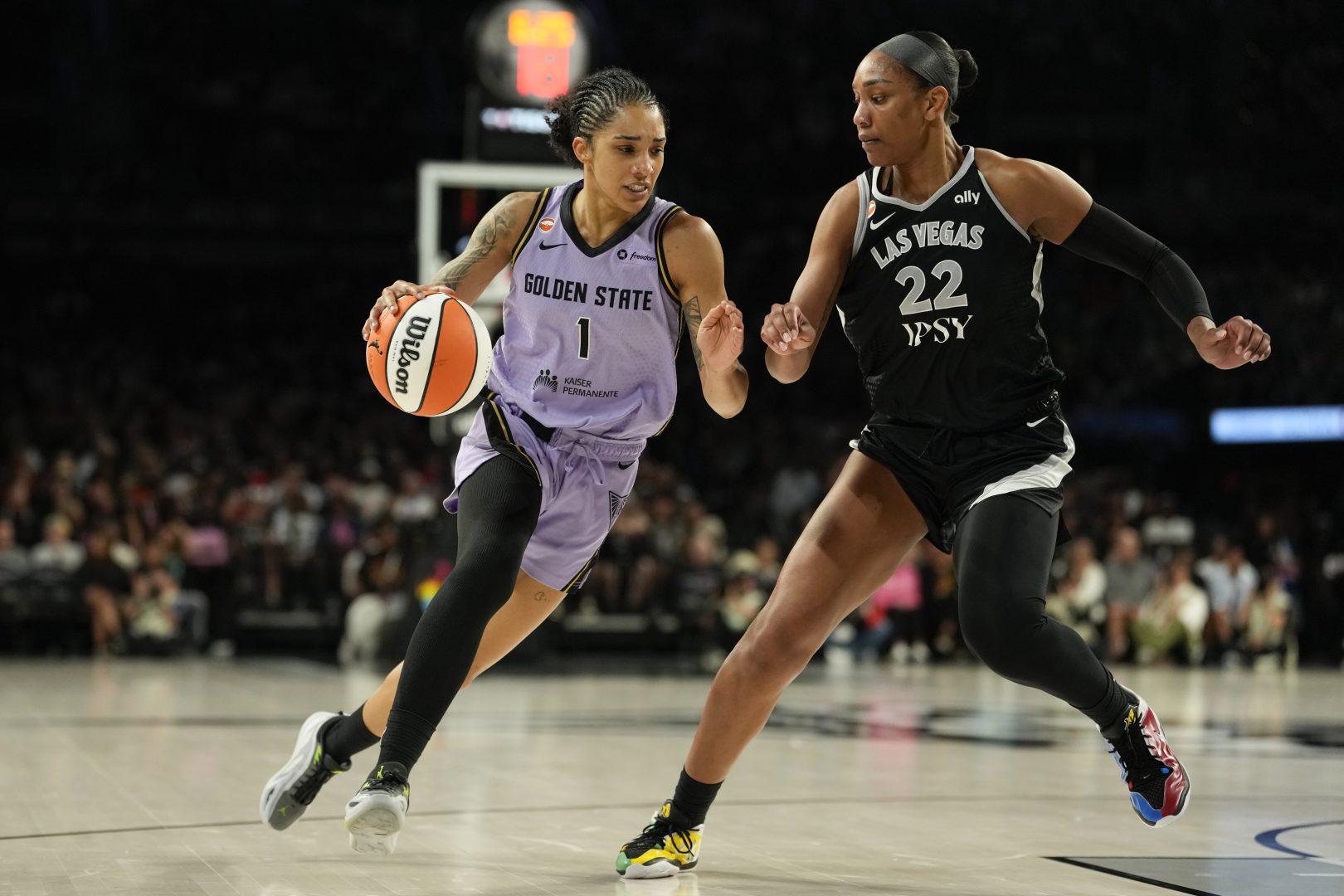 Golden State Valkyries forward Gabby Williams drives against Las Vegas Aces center A'ja Wilson