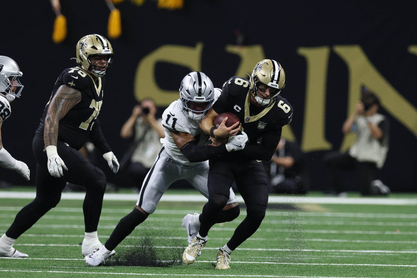 Las Vegas Raiders safety Jeremy Chinn sacks New Orleans Saints quarterback Tyler Shough